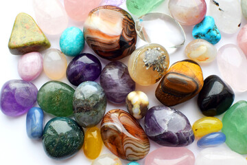 Background made of beautiful natural colored semi-precious stones. Purple fluorite, rose quartz and...