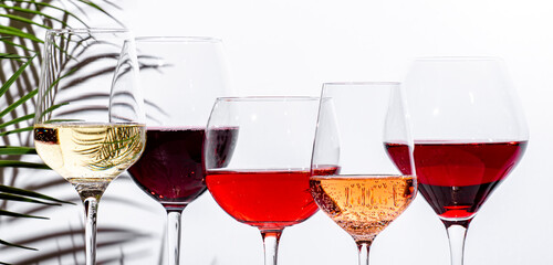 Non-alcoholic, alcohol free wine set. Red, white, rose wines in glasses. White background, shadows,...