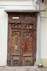 Weathered Historic Wooden Door with Carved Details in Old Town Vilnius, Lithuania