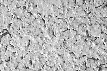 A white wall trexture with flaking paint in closeup