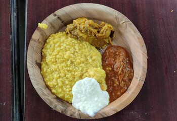 Vegetarian meal in Indian Hindu temple consisting Khichdi, Sabji, Tomato chutney and Kheer. 