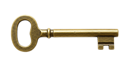 A close up shot of an antique brass key isolated on a black background in a horizontal composition