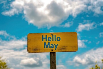 A yellow wooden road sign with the text "Hello May" written in blue on it, against a sky background Generative AI