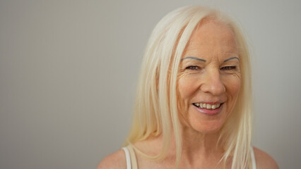 Woman with albinism smiling confidently against a white background showcasing natural beauty and...