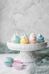 Mini Vanilla Cupcakes Frosted with Pastel Buttercream Icing on a White Pedestal