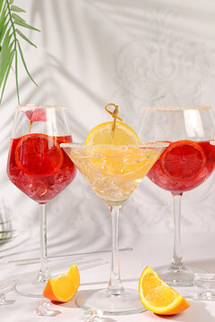 Flyer with various alcoholic drinks with tropical fruits, margarita, aperol sprits cocktail with slices of blood orange, grapefruit, with rum from tequila, rum, vodka and ice. Summer party concept,