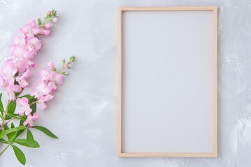 Vertical blank wooden frame on grey marble background with soft pink flowers, minimal pastel styled space, clean copy space for artwork or design

