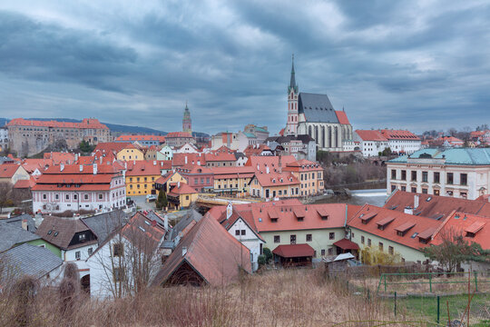 Panoramic view of the historic center with red roofs and church in Cesky Krumlov, Czech Republic