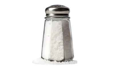 Close up view of a glass salt shaker with metal lid on a black background on transparent background