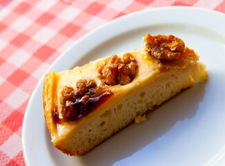 Sweet dessert, cake with walnuts on white plate