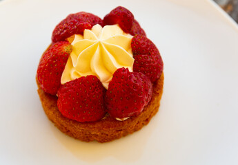 Delicious dessert with strawberry decorated with whipped cream