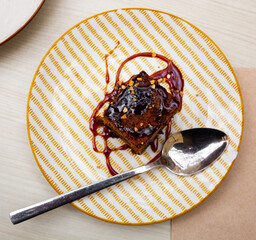 Slice of fresh carrot cake served on plate. Confectionery served on table in restaurant.