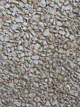 Natural stone wall with textured surface in gray tones