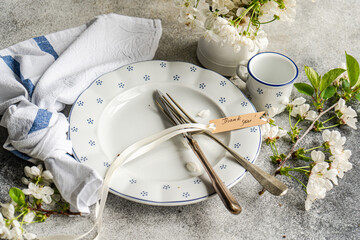 Elegant Table Setting with Floral Decor and Thank You Note