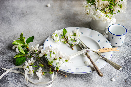 Fototapeta Elegant table setting with white blossoms and vintage charm