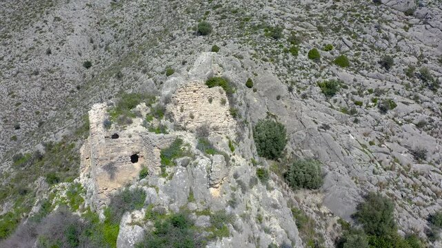Aerial view of the ruins of Travadell Castle on a peak, chronologically located in Millena in the middle of the 12th century, in the interior of the province of Alicante, Spain.