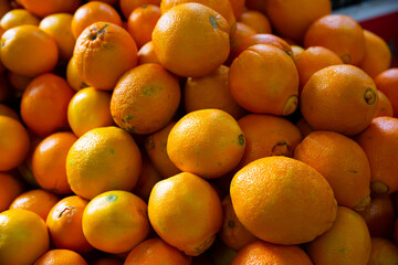 Showcase with fresh oranges in greengrocery