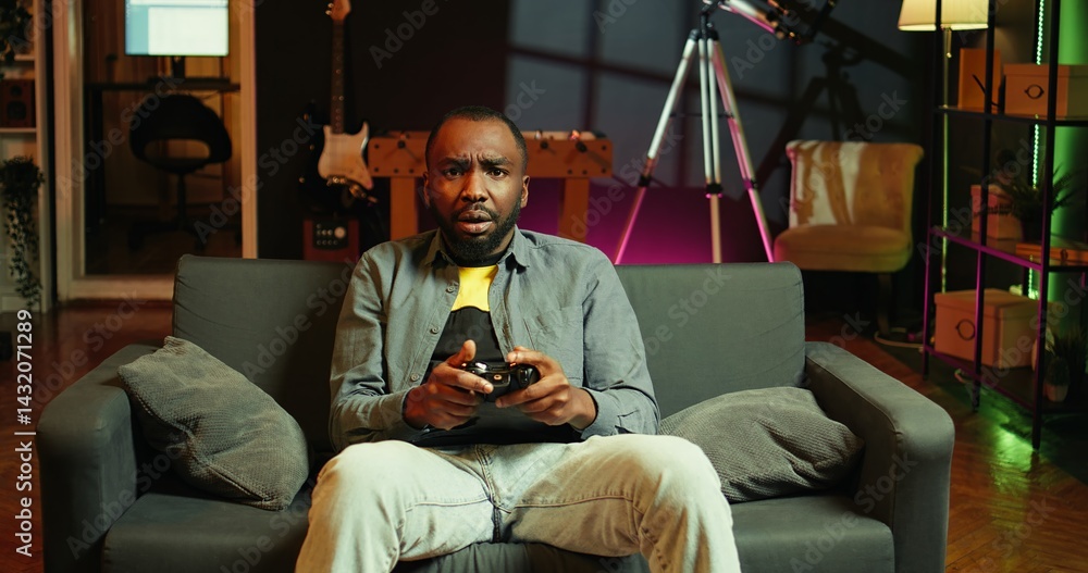 Poster gamer upset after losing while playing videogames on console system using controller. man putting fa