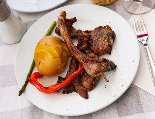Roasted lamb ribs, pepper and potato slices served on plate