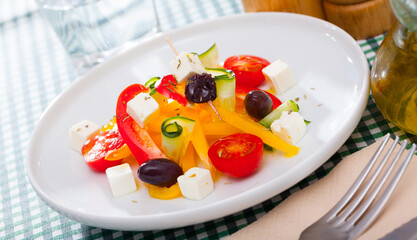 Delicious salad with tomatoes, cucumber, feta cheese and paprika. High quality photo