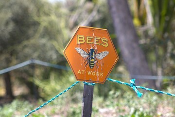 bees at work hexagonal sign
