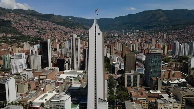 Drone footage of the Coltejer Building in the downtown of Medellin city, Colombia on a sunny day