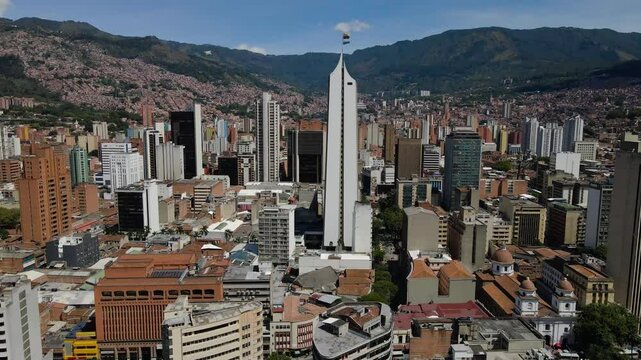 Ascending drone footage of the urban buildings at the downtown of Medellin, Colombia on a sunny day