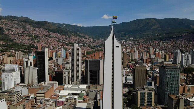 Pull-back drone footage of the urban buildings at the downtown of Medellin city, Colombia