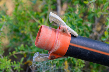 Macro shot of a plastic water pipe with quick-connect fittings, demonstrating ease of installation...