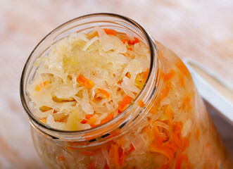Glass jar with traditional Russian sauerkraut on table, nobody