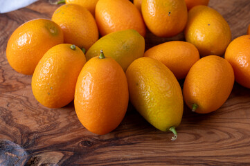 Delicious small citrus fruits orange kumquats close up