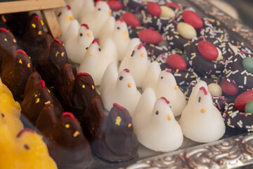 Various Easter-themed confectionery, marmalade chickens, chocolates and eggs, on display counter in old traditional candy shop in Vienna, Austria