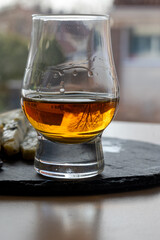 Whiskey and cheese pairing, tasting whisky glass and plate with sliced blue stilton and blue shropshire cheeses, Great Britain food and drink