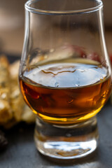 Whiskey and cheese pairing, tasting whisky glass and plate with sliced blue stilton and blue shropshire cheeses, Great Britain food and drink