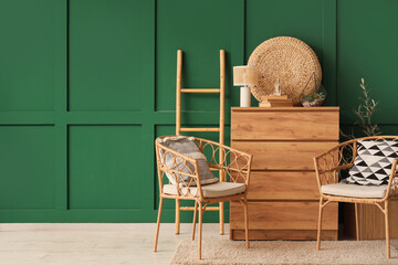 Interior of living room with wooden commode, armchairs and ladder