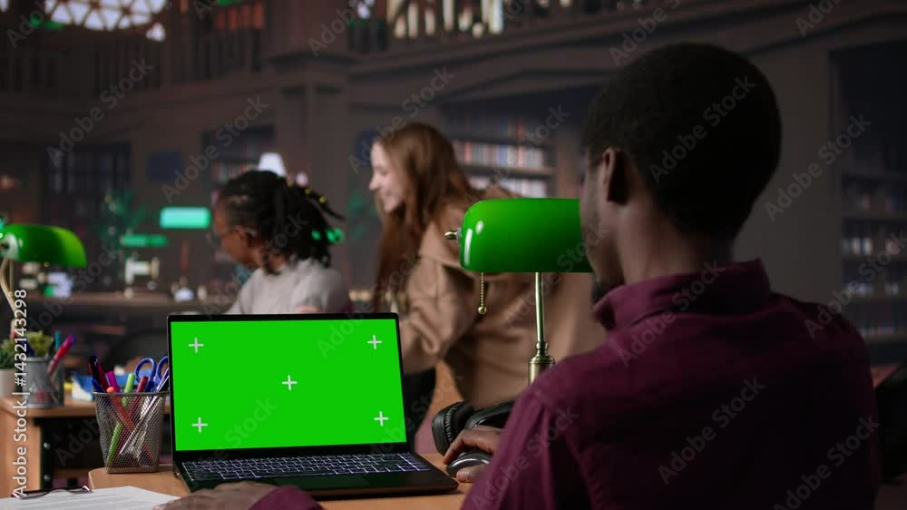 Poster college student looks at a copy space on laptop while collecting notes from reliable academic source