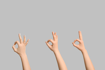 Female hands showing OK on light background