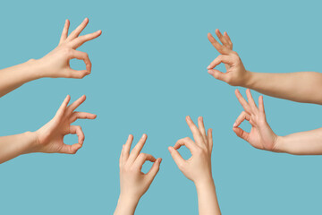 Female hands showing OK on blue background