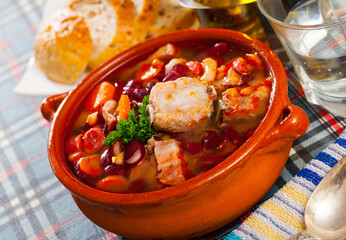 Pork cooked with bean, carrots and greens, served in bowl