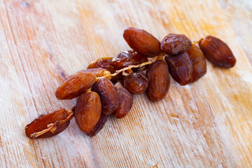 Tasty dried date on wooden table close up, traditional mediterranean fruit