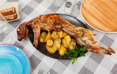 Appetizing roasted rabbit with potatoes and parsley