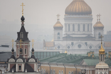 Cityscape with several Orthodox church domes, including the Cathedral of Christ the Saviour, seen through morning fog in Moscow, Russia