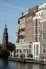 Naklejka premium Amsterdam Canal with Historic Buildings and Church Tower