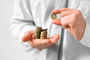 Businessman counting coins, closeup view