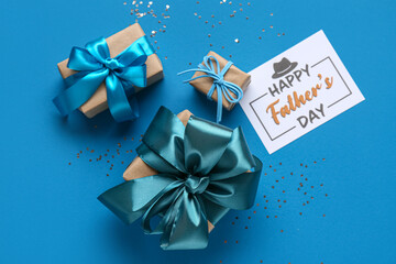 Postcard with gift boxes and confetti for Father's Day on blue background