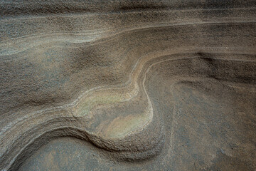 Smooth, undulating sandstone formations display mesmerizing patterns carved by natural erosion