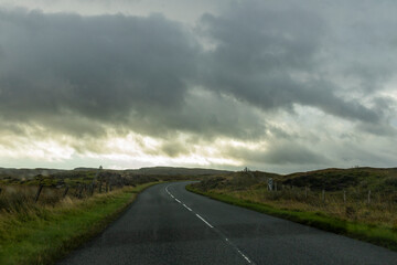 Winding roads cut through the natural wonders of the Isle of Skye: cliffs, rugged coastlines, and...