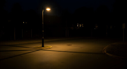 Solitary Light: Urban Street Scene Illuminated in Dark Night