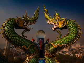 Chonburi, Thailand, Febuary 12, 2025, Impressive twin nagas guard the entrance to Samnaksong Khao...