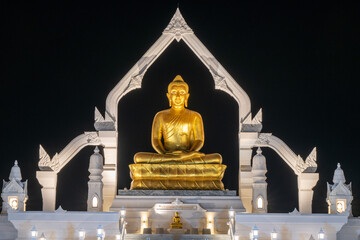 Lopburi, Thailand, April 12, 2025, Stunning golden Buddha statue illuminated at Puttha Sathan...